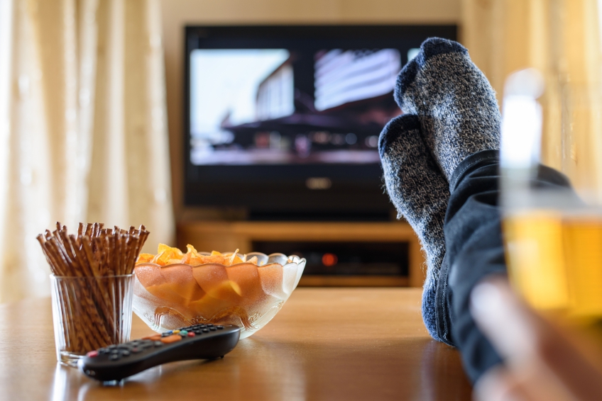 Television, TV watching (movie) with feet on table and huge amounts of snacks