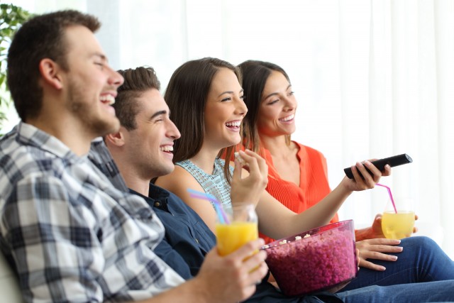 Happy friends watching tv from Cheap LED TVs