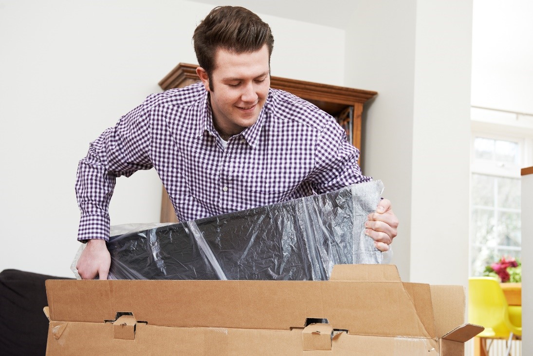 unpacking a cheap led tv in the living room