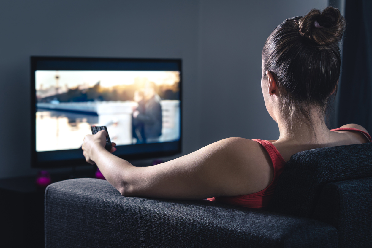 Woman streaming movie or watching series. Person using smart tv 
